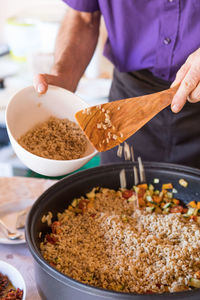 Midsection of man preparing food