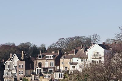 Buildings in city against clear sky