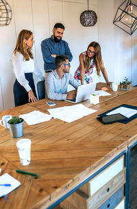 Business people in a meeting standing evaluating a trainee worker