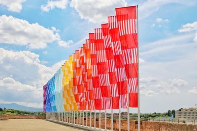 Red flag against cloudy sky