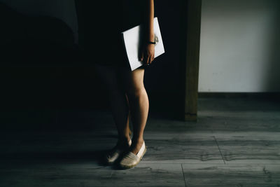 Low section of woman standing on floor