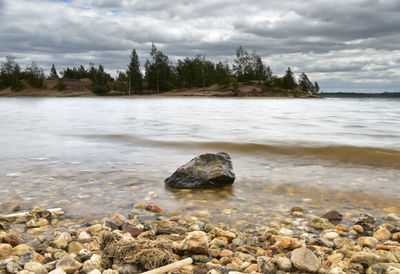 Rocks on beach against sky