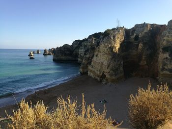 Scenic view of sea and rocky mountains
