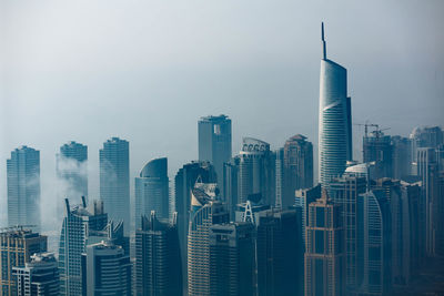 Modern buildings in city against sky