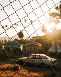 Close-up of chainlink fence against sky