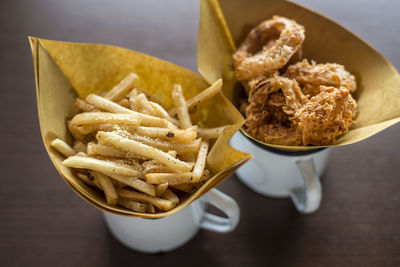 High angle view of meat and fries in plate on table