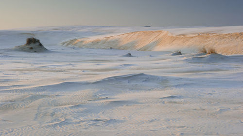 Scenic view of beach against clear sky