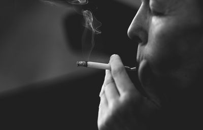 Close-up of man smoking cigarette