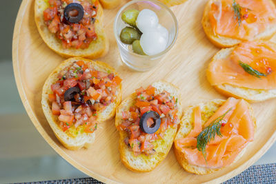 Tapas which is small portion appetizer food smoked salmon, cooked tomato and parma ham 