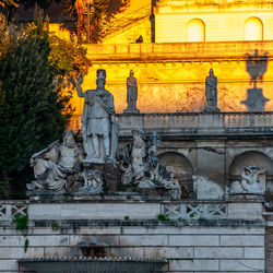 Low angle view of statue against building