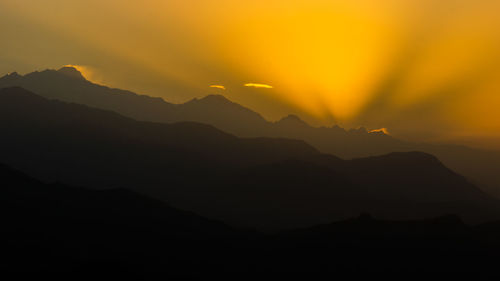 Silhouette of mountain against sky at sunset