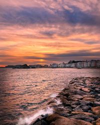 Scenic view of dramatic sky over sea during sunset