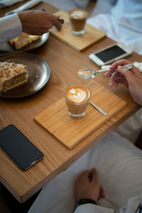 High angle view of man having coffee on table