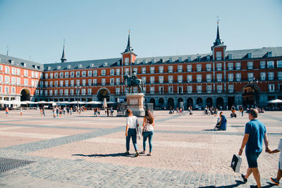 People at town square against clear sky