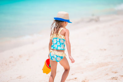 Rear view of child on beach