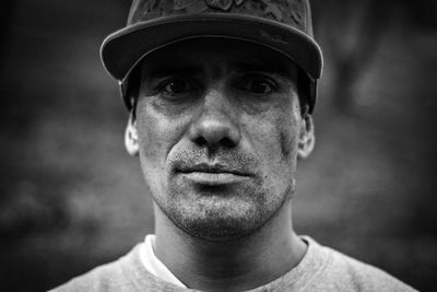 Close-up portrait of mid adult man wearing cap while standing outdoors