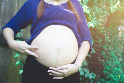 Midsection of woman touching hair