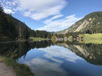 Scenic view of lake by trees against sky