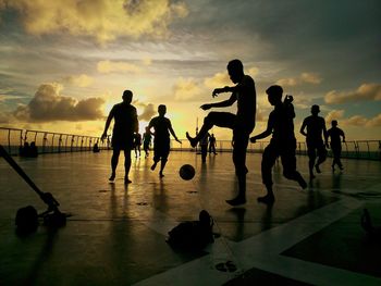 People playing against sky during sunset