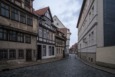 Street amidst buildings against sky