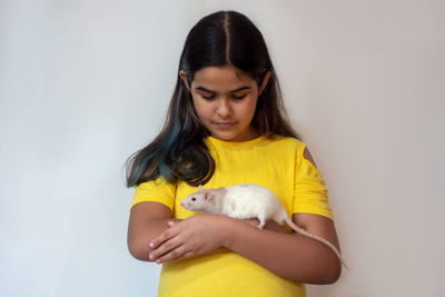  teenage girl with rat against white background