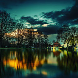 Scenic view of lake against sky at dusk