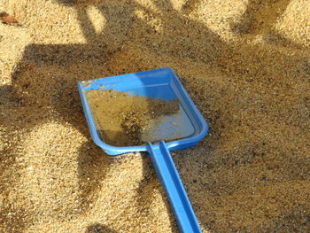 High angle view of shovel on sand