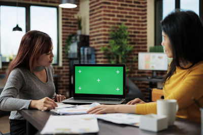 Business colleagues working on laptop at office