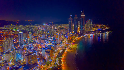 High angle view of illuminated city buildings at night