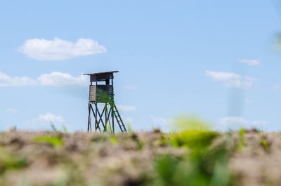 Lighthouse by sea against sky
