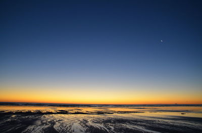 Scenic view of sea against clear sky during sunset