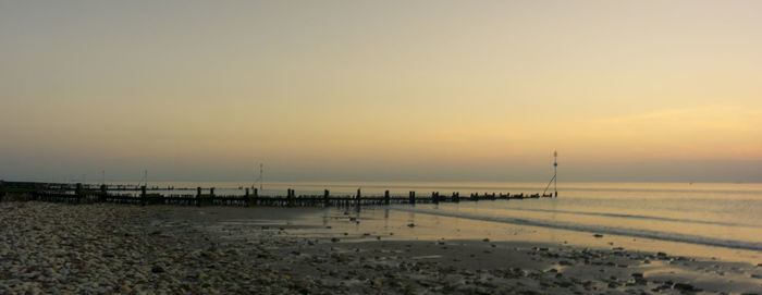 Scenic view of beach against sky during sunset