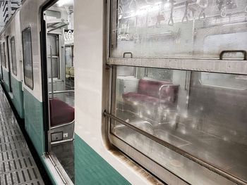 Train at railroad station seen through glass window