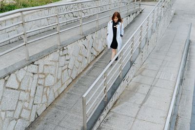 High angle view of woman walking on walkway