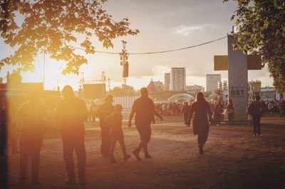 People in city at sunset