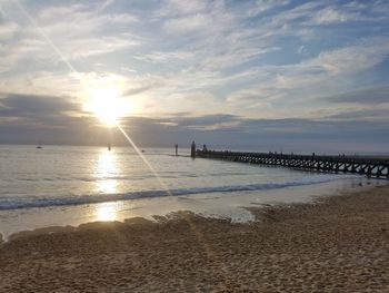 Scenic view of beach against sky during sunset