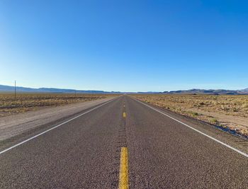 Empty road along countryside landscape