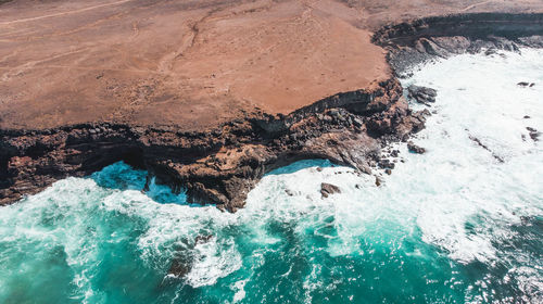 High angle view of rocks in sea