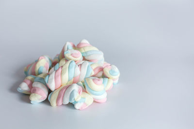 Close-up of multi colored candies against white background