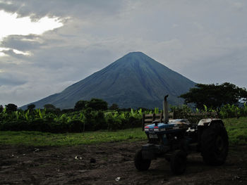 Tractor on field against sky