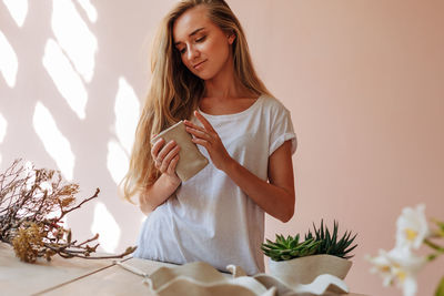 Young woman making ceramics in workshop