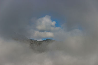Low angle view of volcanic mountain against sky