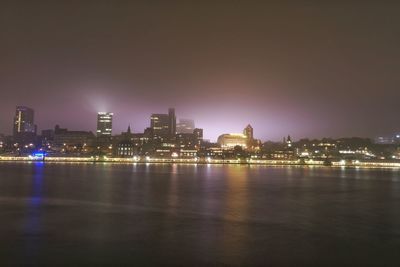 Illuminated city buildings at waterfront