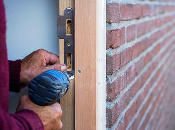 Close-up of man working on door