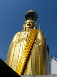 Low angle view of statue against blue sky