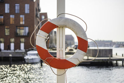 Close-up of umbrella on pole against river