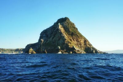 Scenic view of sea against clear blue sky