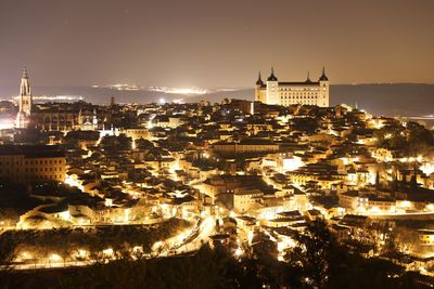 High angle view of illuminated buildings in city at night