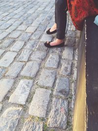 Low section of woman standing on tiled floor