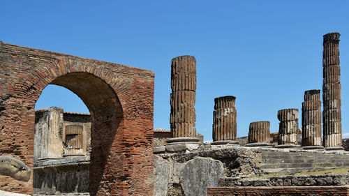 Low angle view of old building against blue sky